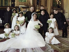 In this photo released by Kensington Palace on Monday May 21, 2018, shows an official wedding photo of Britain's Prince Harry and Meghan Markle, center, in Windsor Castle, Windsor, England, Saturday May 19, 2018. Others in photo from left, back row, Brian Mulroney, Remi Litt, Rylan Litt, Jasper Dyer, Prince George, Ivy Mulroney, John Mulroney; front row, Zalie Warren, Princess Charlotte, Florence van Cutsem. (Alexi Lubomirski/Kensington Palace via AP) ORG XMIT: LON817