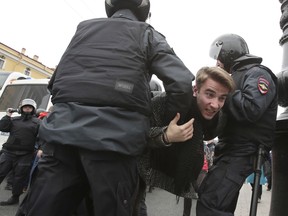 Russian police detain a protester at a demonstration against President Vladimir Putin in St. Petersburg, Russia, Saturday, May 5, 2018.