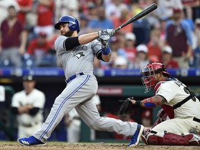 Toronto Blue Jays' Russell Martin hits a single to score Justin Smoak off Philadelphia Phillies' Aaron Nola during the seventh inning of a baseball game, May 26, 2018, in Philadelphia. (AP Photo/Derik Hamilton)