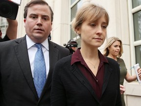 Former Smallville star Allison Mack enters a New York court with her lawyer to face sex trafficking charges.