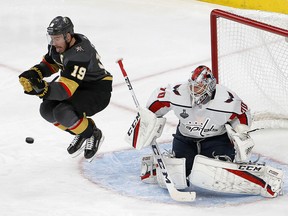 Vegas Golden Knights winger Reilly Smith, left, jumps out of the way of a shot that was stopped by Washington Capitals goaltender Braden Holtby Wednesday, May 30, 2018, in Las Vegas. (AP Photo/Ross D. Franklin)
