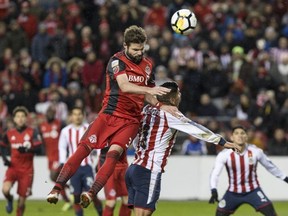 Toronto FC's Drew Moor (3) rises above Guadalajara's Carlos Salcido to send a header close to goal during second half CONCACAF Champions League final first leg action against Chivas de Guadalajara, in Toronto on Tuesday, April 17, 2018. THE CANADIAN PRESS/Chris Young