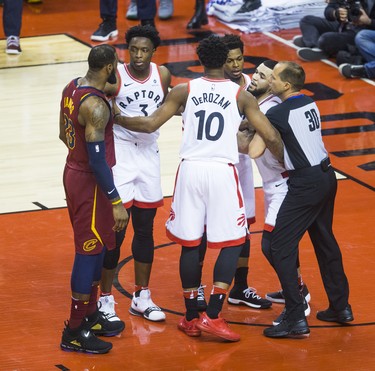 Toronto Raptors Fred VanVleet is held back during 1st half action against Cleveland Cavaliers LeBron James in Eastern Conference Semifinals at the Air Canada Centre at the Air Canada Centre in Toronto, Ont. on Tuesday May 1, 2018. Ernest Doroszuk/Toronto Sun/Postmedia Network