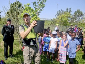 School children, members from the Rotary Club veterans and currently serving members of the Canadian Armed Forces plant 500 trees at Meadowvale Rd and the 401 on Thursday May 24, 2018. The Highway of Heroes Tree Campaign plans to plant 117,000 trees,one for every fallen Canadian soldier. (Veronica Henri/Toronto Sun)