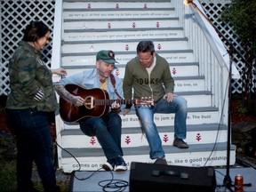 Singer-songwriter Dallas Green gets some help from The Hip's bassist Gord Sinclair as he prepares to perform Thursday night at the band's The Bathouse recording studio.