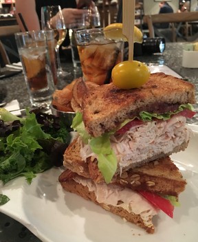 A turkey breast club sandwich on nine grain bread served with house-made chips and organic garden salad from Vaudeville Bistro in Fredericksburg. (Ling Hui/Postmedia Network)