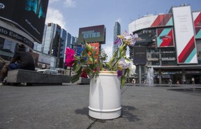 A single bouquet of flowers near the scene where a man was gunned down at Yonge-Dundas Square the previous night in Toronto, Ont. on Thursday May 31, 2018. Ernest Doroszuk/Toronto Sun