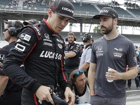 James Hinchcliffe, right, talks with Robert Wickens during qualifications for the IndyCar Indianapolis 500 in Indianapolis Sunday, May 20, 2018. (AP Photo/Darron Cummings)