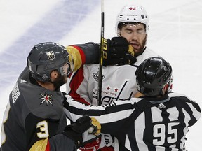 Vegas Golden Knights defenceman Brayden McNabb, left, hits Washington Capitals winger Tom Wilson as linesman Jonny Murray tries to break it up during Game 1 of the Stanley Cup final Monday, May 28, 2018, in Las Vegas. (AP Photo/Ross D. Franklin)