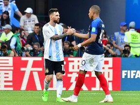 Argentina's Lionel Messi congratulates France's Kylian Mbappe after Saturday's game. (GETTY IMAGES)