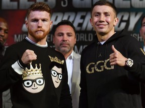 Golden Boy Promotions Chairman and CEO Oscar De La Hoya (C) looks on as Canelo Alvarez (L) and WBC, WBA and IBF middleweight champion Gennady Golovkin pose during a news conference at MGM Grand Hotel & Casino on September 12, 2017 in Las Vegas, Nevada. (Ethan Miller/Getty Images)