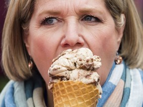 Ontario NDP leader Andrea Horwath take a bite of her ice cream cone during a campaign stop in Guelph on June 5.(THE CANADIAN PRESS)