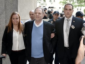 Disgraced film producer Harvey Weinstein, in bracelets, does the New York perp walk.