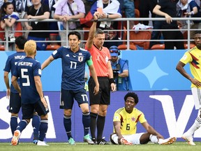 Slovenian referee Damir Skomina shows a red card to Colombia midfielder Carlos Sanchez during Tuesday's game. (GETTY IMAGES)