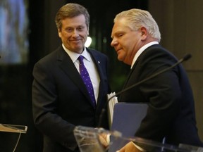 Premier-designate Doug Ford (right) and Mayor John Tory are pictured at a mayoral debate in October, 2014. Tory beat Ford in that year's mayoral race.