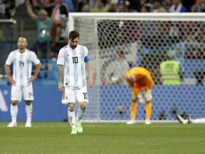 Argentina's Lionel Messi looks down as he walks on the pitch after Thursday's loss to Croatia. (AP PHOTO)