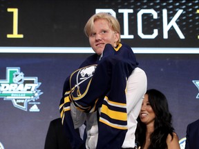 Rasmus Dahlin puts on a jersey after being selected first overall by the Buffalo Sabres in Friday’s NHL draft. (GETTY IMAGES)