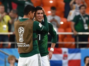 Mexico's defender Edson Alvarez is comforted by a teammate after Wednesday's loss to Sweden. (GETTY IMAGES)