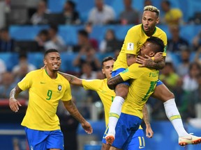 Brazil's Paulinho (right) celebrates with teammates after scoring his team's first goal on Wednesday against Serbia. (GETTY IMAGES)