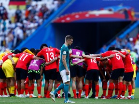 Germany's Toni Kroos walks past a celebrating South Korean side after Wednesday's game. (GETTY IMAGES)