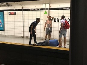 Screenshot of Good Samaritans helping a visually-impaired man who fell on the subway tracks.