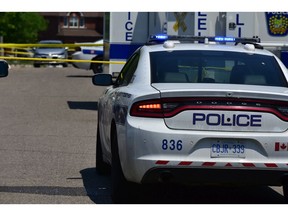 Peel Regional Police cruiser and command post at a crime scene. (Bryan Passifiume/Toronto Sun)