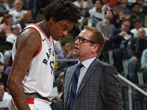 Lucas Nogueira and Raptors assistant coach Nick Nurse speak during a playoff game against the Washington Wizards on April 17, 2018