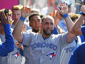 Kendrys Morales of the Toronto Blue Jays is congratulated in the dugout after hitting a go-ahead solo home run in the tenth inning game against the Los Angeles Angels of Anaheim at Angel Stadium on June 24, 2018 in Anaheim, Calif. (Jayne Kamin-Oncea/Getty Images)