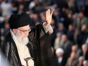 A handout picture provided by the office of Iran's Supreme Leader Ayatollah Ali Khamenei on June 4, 2018 shows him greeting the crowd during a ceremony on the occasion of the 29th anniversary of the death of the founder of the Islamic Republic, Ayatollah Ruhollah Khomeini at his mausoleum in a suburb of Tehran. (AFP PHOTO/HO/KHAMENEI.IR)