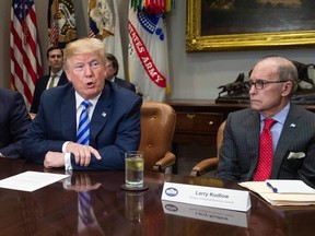 US President Donald Trump with his economic adviser Larry Kudlow (NICHOLAS KAMM/AFP)