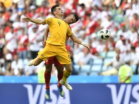 Peru's Anderson Santamaria, background, and Australia's Tomi Juric go for a header during the group C match between Australia and Peru, at the 2018 soccer World Cup in the Fisht Stadium in Sochi, Russia, Tuesday, June 26, 2018.