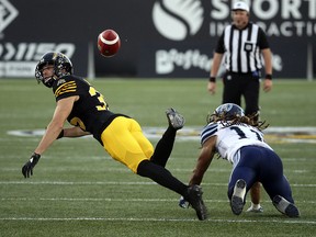 Hamilton Tiger-Cats DB Mike Daly (35) breaks up a pass intended for Toronto Argonauts Alex Charette during pre-season CFL action in Hamilton on Friday June 1, 2018. (Jack Boland/Toronto Sun)