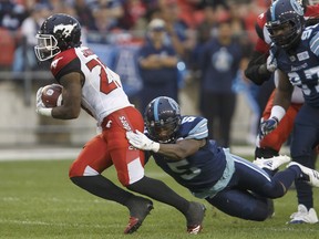 Argonauts defensive back Jermaine Gabriel fails to bring down Calgary Stampeders running back Don Jackson during the first half on Saturday night at BMO Field. (Cole Burston/The Canadian Press)