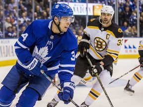 Maple Leafs star Auston Matthews tries to elude Boston Bruins defenceman Zdeno Chara at the Air Canada Centre in Toronto Thursday, April 19, 2018. (Ernest Doroszuk/Toronto Sun)