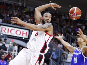 Canada’s Cory Joseph passes the ball off against Dominican Republic’s Adris Geraldo De Leon Jimenez during their FIBA basketball world cup qualifier game at the Ricoh Coliseum last night.  Mark Blinch/The Canadian Press