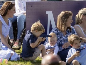 Britain's Kate, the Duchess of Cambridge, left, sits with Prince George and other unidentified spectators as they watch Prince William take part in the Maserati Royal Charity Polo Trophy at the Beaufort Polo Club, in Tetbury, England, Sunday June 10, 2018. (Steve Parsons/PA via AP) ORG XMIT: AMB817