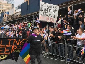 A Pride parade participant carries an anti-police sign. (SUE-ANN LEVY, Toronto Sun)