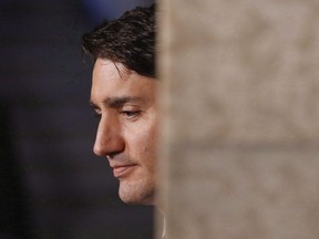 Prime Minister Justin Trudeau listens at a press conference on Parliament Hill in Ottawa on June 7, 2018.