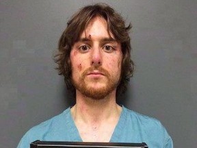 Justin Bourque is shown in this RCMP booking photo taken June 6, 2014. One of Canada's most notorious killers ??? who murdered three RCMP officers and wounded two others - has taken to an online matchmaking website where he portrays himself as "a blue collar dude with a passion for music." THE CANADIAN PRESS/HO-RCMP