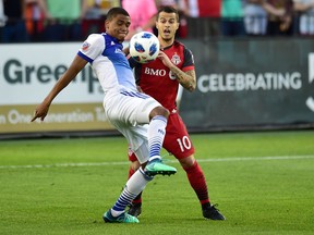 FC Dallas defender Reggie Cannon and Toronto FC forward Sebastian Giovinco battle for the ball during MLS action on May 25, 2018