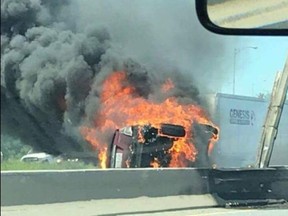 A vehicle on fire on the QEW in Burlington on Monday, June 25, 2018. (Kerry Schmidt/Twitter)
