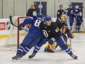 Eric Cooley (left) and Sean Durzi battle during Maple Leafs Development Camp on Wednesday at the MasterCard Centre. (Ernest Doroszuk/Toronto Sun)