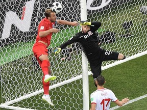 England's forward Harry Kane (L) vies for the ball with Tunisia's goalkeeper Mouez Hassen (R) during the Russia 2018 World Cup Group G football match between Tunisia and England at the Volgograd Arena in Volgograd on June 18, 2018.