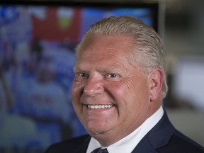 Ontario Premier-designate Doug Ford arrives at the Postmedia offices in Toronto for an interview with the Toronto Sun and greets supporters on his way into the building on Friday June 8, 2018. (Stan Behal/Toronto Sun/Postmedia Network)