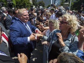 Ontario Premier Doug Ford greets people outside of Queen's Park after being sworn-in on Friday. (Ernest Doroszuk/Toronto Sun)