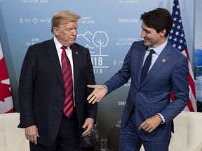Canada’s Prime Minister Justin Trudeau shakes hands with U.S. President Donald Trump during a meeting at the G7 leaders summit in La Malbaie, Que., on Friday, June 8, 2018.