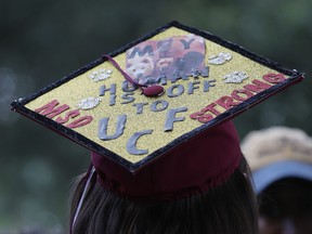 Shannon Recor, a graduate of Marjory Stoneman Douglas High School, wears a mortar board where she wrote, 'My human is off to UCF MSD Strong,' after attending the graduation ceremony at the BB&T Center on June 3, 2018 in Sunrise, Florida. (Cait Christenson not pictured)