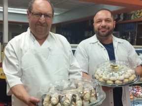 Sal Mucio Sr., with one of his sons, Joe, presenting fresh cannoli pastries