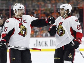 Ottawa Senators' Mike Hoffman (68) celebrates his power play goal with Erik Karlsson (65), of Sweden, during the third period of an NHL hockey game against the Philadelphia Flyers, Saturday, April 2, 2016, in Philadelphia. Senators forward Hoffman and his fiancee Monika Caryk say they have nothing to do with the cyberbullying of Melinda Karlsson, the wife of Senators captain Erik Karlsson.