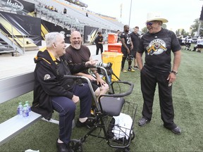 Legendary lineman Angelo Mosca (left) talks with Ticats defensive coordinator  Jerry Glanville (right) on the sidelines at practice in Hamilton on Wednesday. Veronica Henri/Toronto Sun